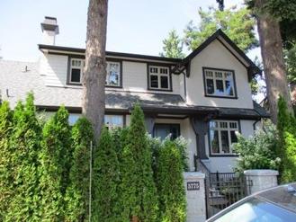 A blue Edwardian heritage house with a deep covered porch